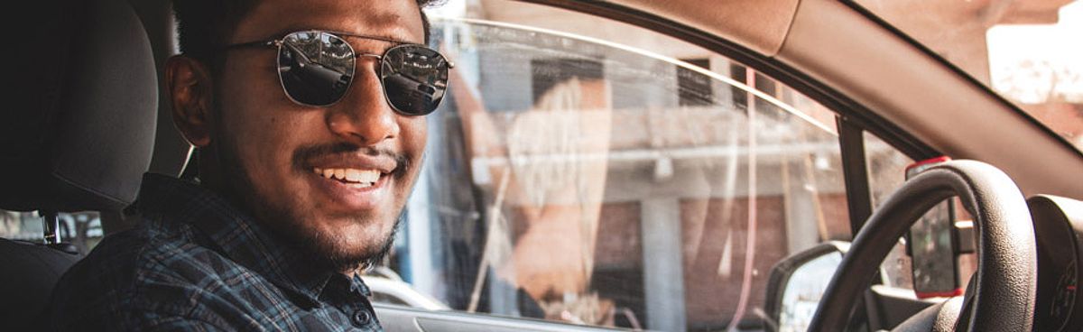 Cheerful man driving a car